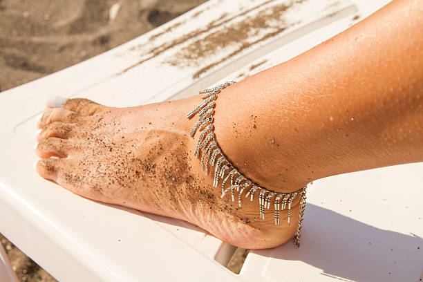 leg of a young girl and anklet ankle - ankle human foot women pedicure imagens e fotografias de stock