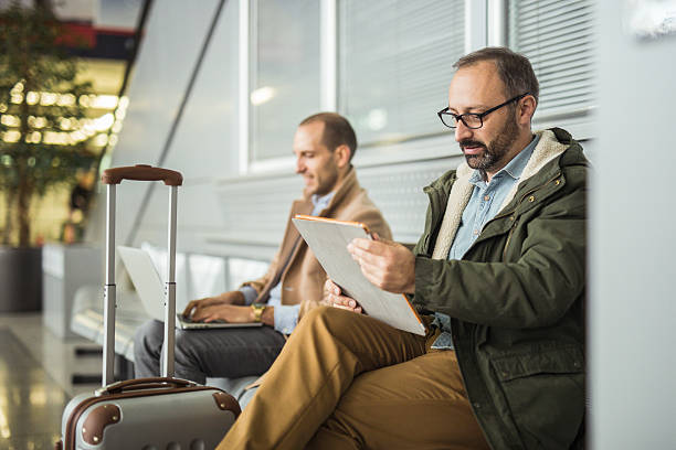 istock Man using digital tablet at the airport lounge 628897348