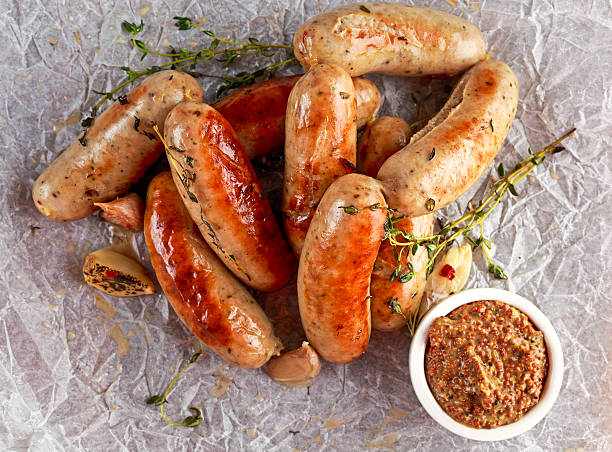 istock Home-made Pork Sausages on crumpled paper with thyme 628897516