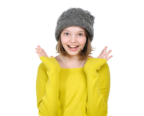 Portrait of laughing (happy) teen girl in a knitted hat and bright jersey.