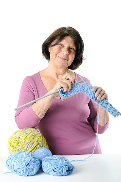 istock Happy elderly woman is engaged in knitting. 628899368