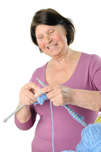 istock Charming elderly woman knitting large needles. 628899446