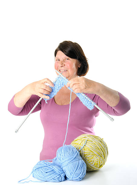 istock Happy elderly woman with yarn and knitting needles. 628899516