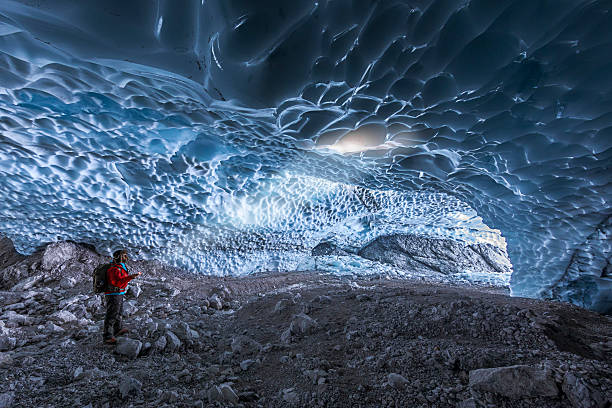 istock Mountaineer lit with torch in ice cave  Berchtesgaden National Park 628900250