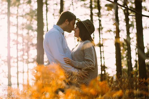 istock Young couple kissing at the forest 628900424
