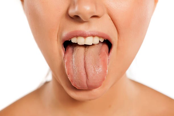 istock young woman stick out her tongue 628900806