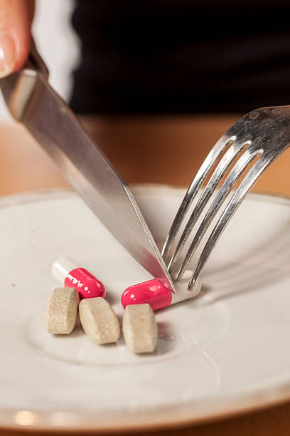 istock knife, fork and drugs in a plate 628900866