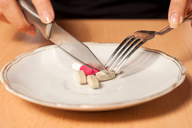 istock knife, fork and drugs in a plate 628900880