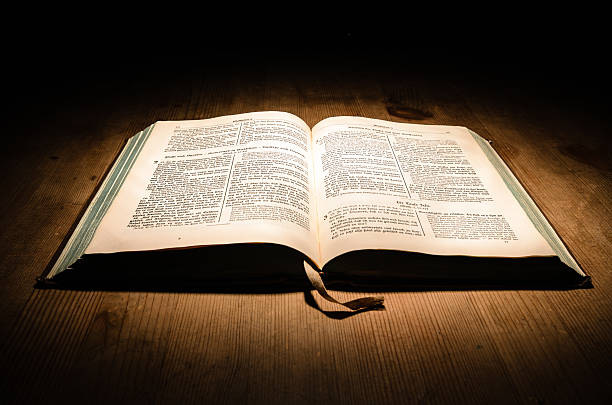 Bible Old bible on a wooden table with dark background catholicism photos stock pictures, royalty-free photos & images