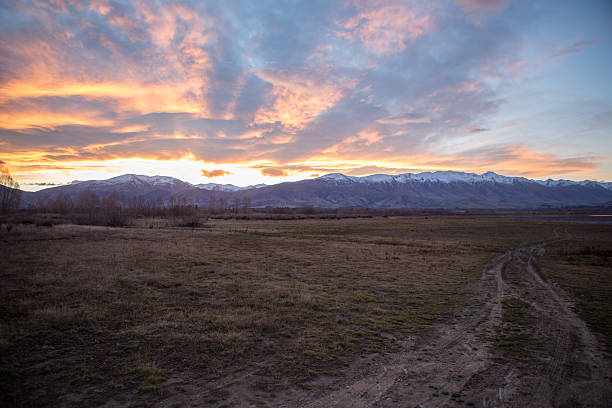 istock Countryside road leading to the lake, fired sky 628908184