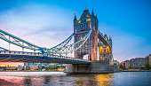 London Tower Bridge illuminated at sunset over River Thames panorama