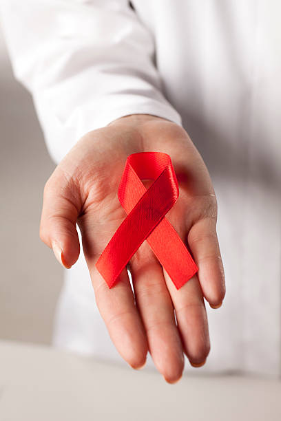istock AIDS ribbon on doctor's hand 628917194