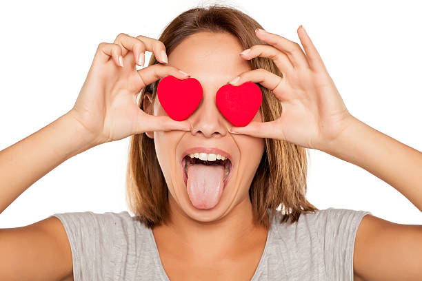 istock happy young woman posing with two small hearts 628917358