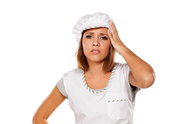istock young beautiful woman posing with a chef's apron and cap 628917624