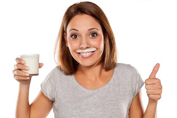 happy young beautiful woman with a yogurt mustache - milk mustache imagens e fotografias de stock