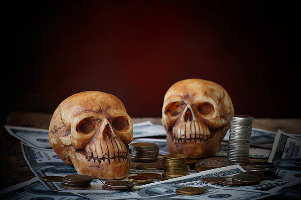 istock skull on bank note and coin, money 628917800
