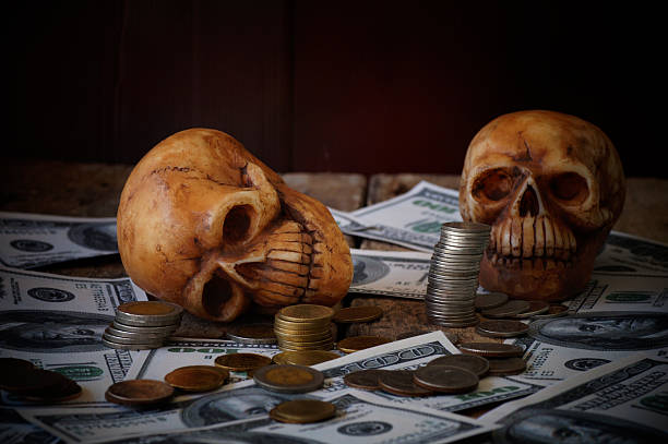 istock skull on bank note and coin, money 628922546
