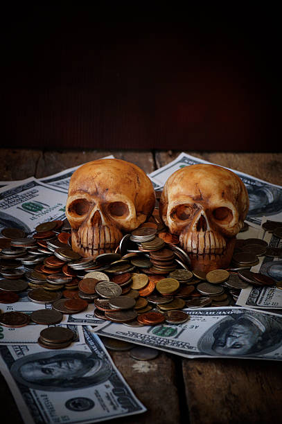 istock skull on bank note and coin, money 628923264