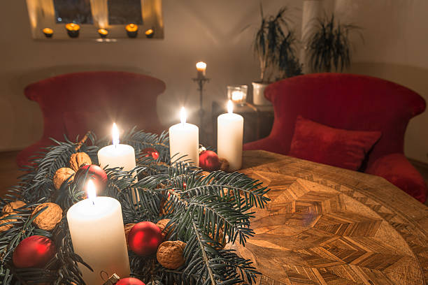 istock Advent candles with decorated fir tree on a ancient table 628924532