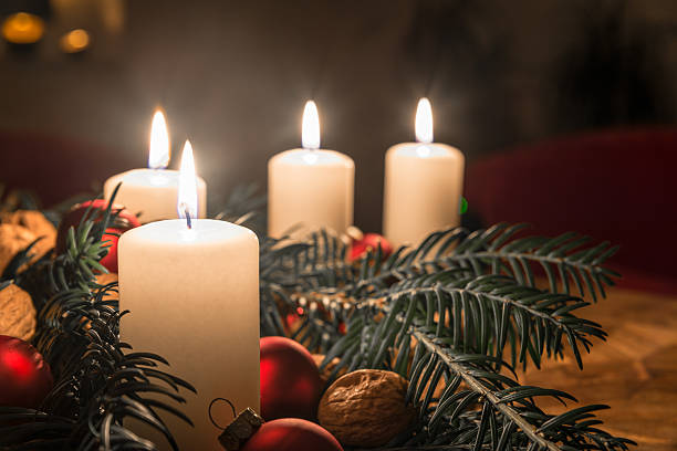 istock Advent candles with decorated fir tree on a ancient table 628924856