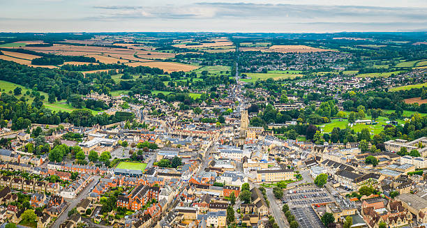 aerial panorama over country town and homes cirencester cotswolds uk - cotswold stockfoto's en -beelden