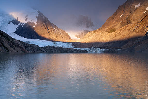 istock The rays of dawn over the mountain lake. 628932480
