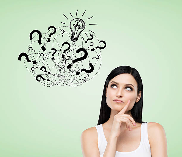 istock Girl with question marks on green background 628933660