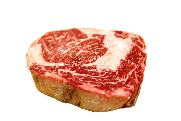 raw ribeye beef lies on a white background. marbled meat. - scotch steak imagens e fotografias de stock