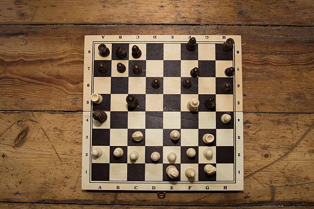 istock Single hand playing chess on a wooden board set 628950290
