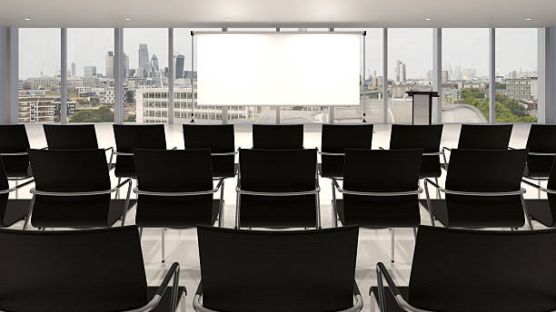 Conference hall Empty conference hall with podium and presentation screens 3D rendering lecture hall training classroom presentation stock pictures, royalty-free photos & images