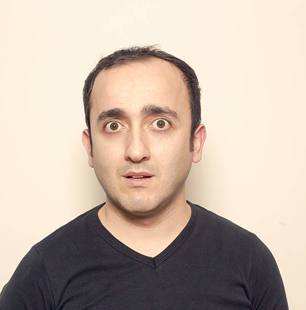 istock Young man making facial expressions 628963424