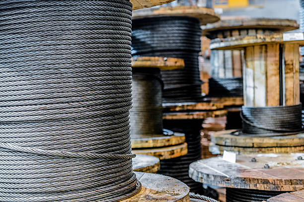 istock Large cable reels stocked in the factory premises. 628963496