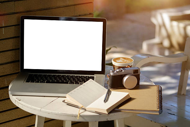 istock Laptop with blank screen on coffee shop table. 628964162