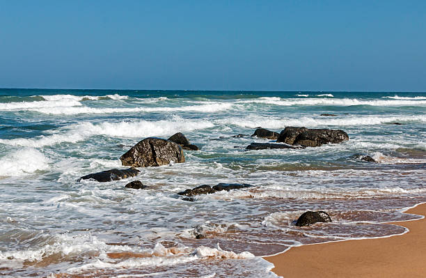 istock Beach Pier Rocks Ocean Waves and  Blue Sky 628964558