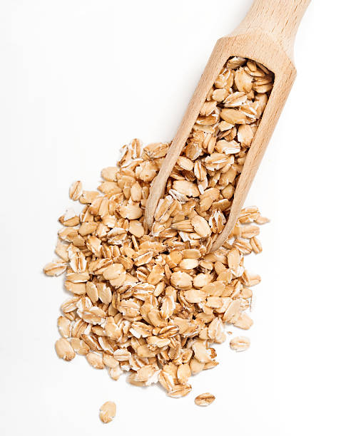 istock Uncooked oat flakes in wooden scoop 628967930
