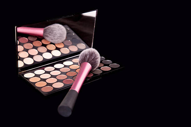 istock Makeup palette with makeup brush on pure black background. 628967998
