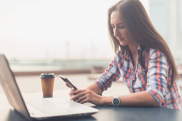 istock Attractive young woman reading a text message on her cell 628968622