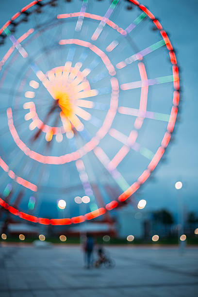 istock Abstract Blur Image Of Illuminated Ferris Wheel In Amusement Park 628974780