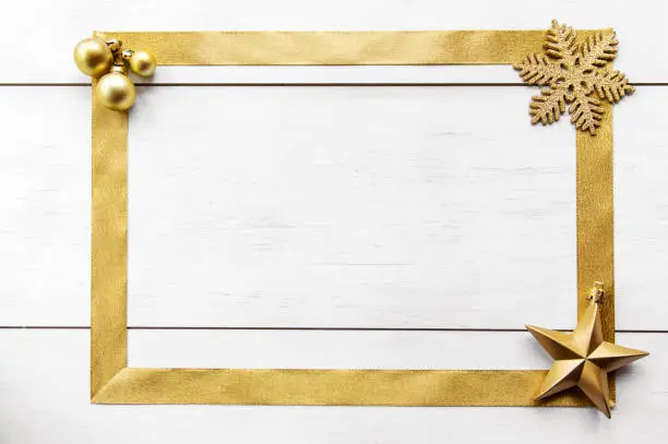 Photo of Wooden background with gold bow