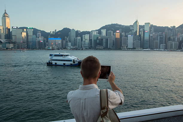 istock Traveler captures Hong Kong skyline on digital tablet 628977616