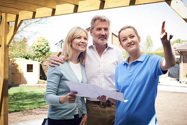 istock Mature Couple Discussing Plan With Landscape Gardener 628977652