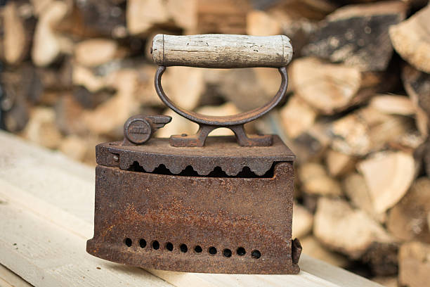 istock Old coal iron on real wood background 628978210