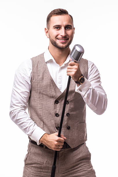 istock showman in suit singing with emotions gesture over the microphone 628978240