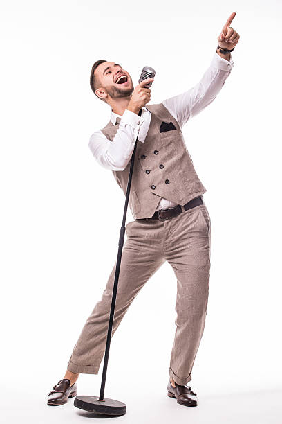 istock Young showman in suit singing with emotions and pointed  gesture 628978696