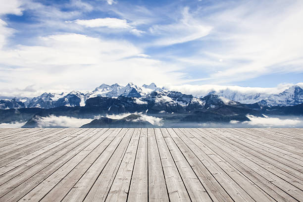 istock Wooden board towards snowcapped mountain 628978726