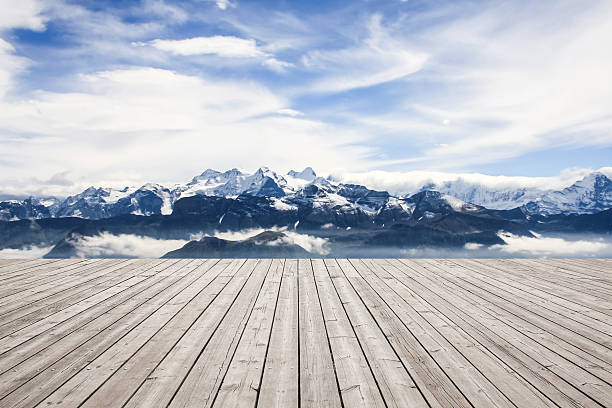 Wooden board towards snowcapped mountain Wooden board towards snowcapped mountain schwyz stock pictures, royalty-free photos & images