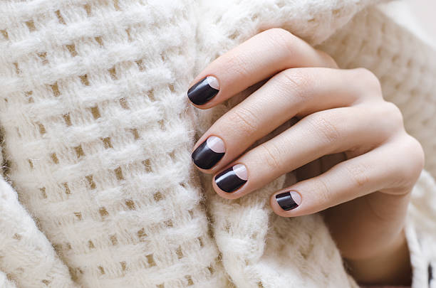 istock Female hands with dark brown nail design 628986318