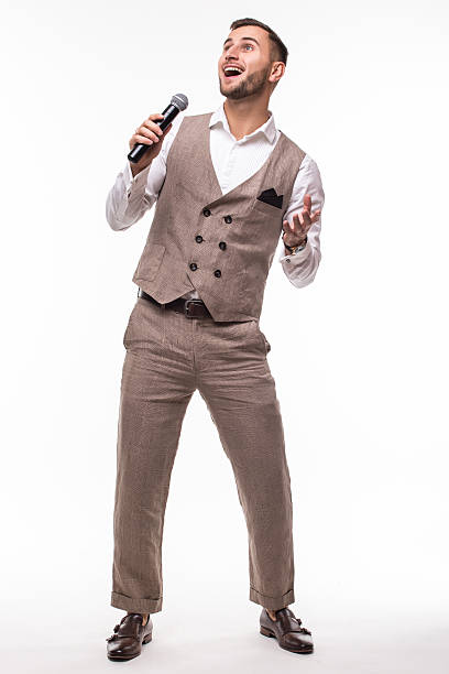 istock Young man in suit singing over the microphone with energy. 628986436