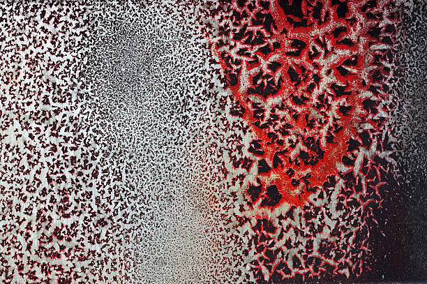 istock Cracked red paint on grunge metal surface - macro 18 628987042