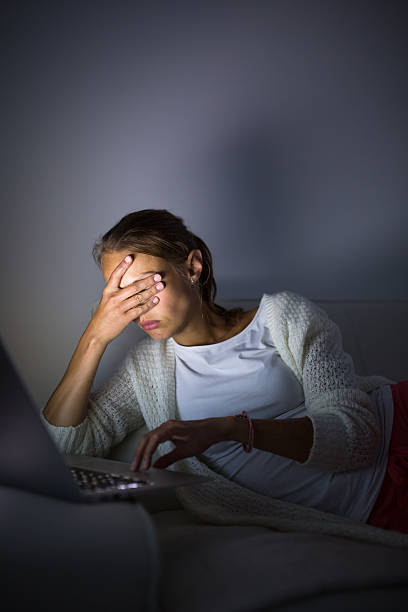 istock Young woman staying up late working on computer 628992394